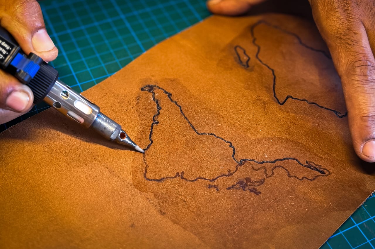 Pyrography detail on cognac full-grain leather